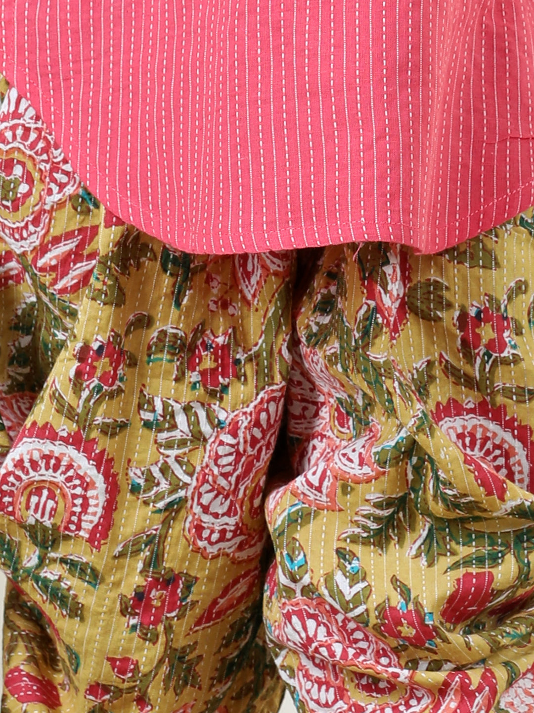 Yellow Floral printed dhoti paired with Peach katha Kurti with a lace border at the neckline