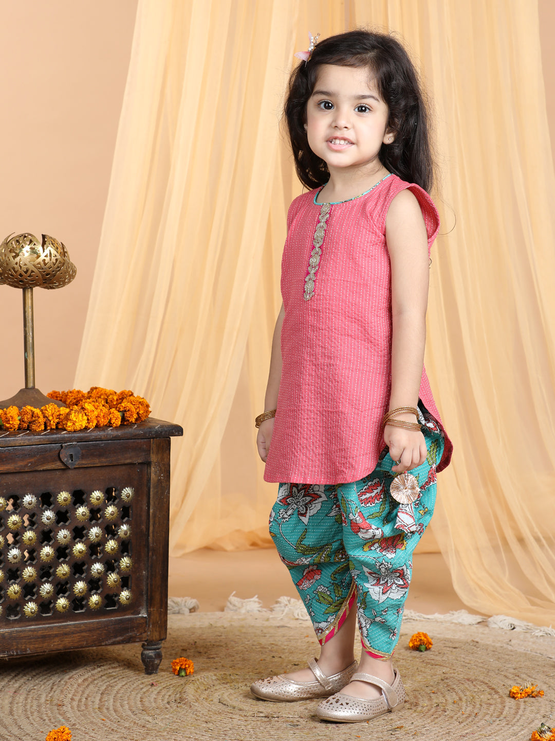 Floral printed dhoti paired with Peach katha Kurti with a lace border at the neckline