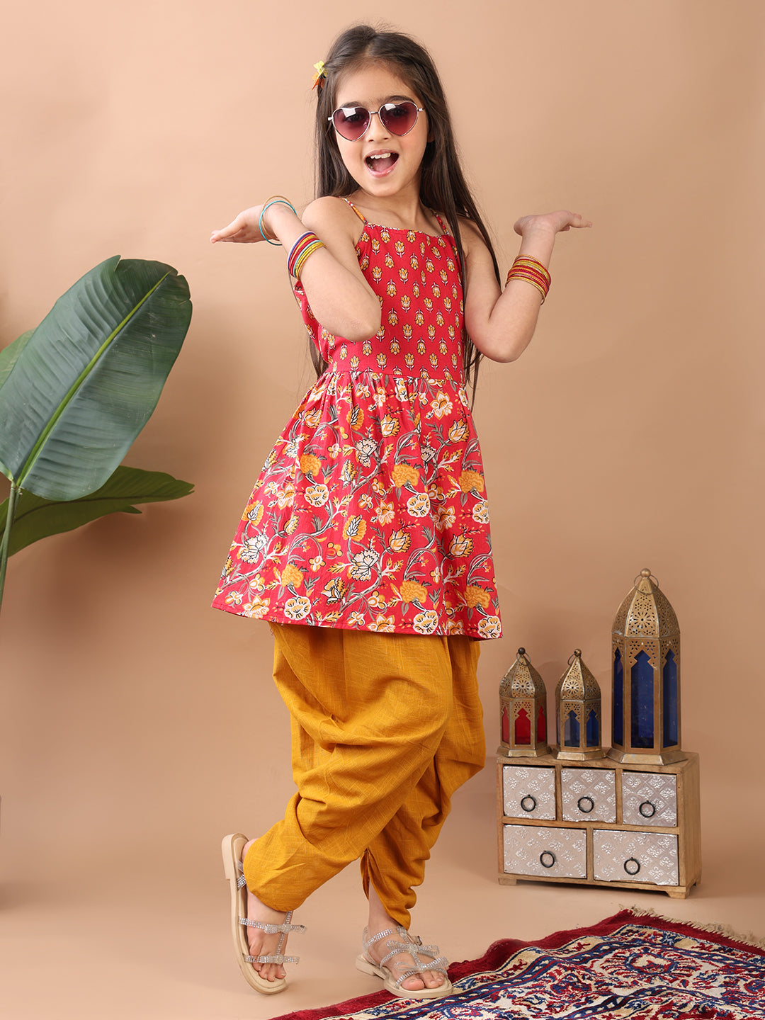Red Floral printed sleeveless Kurti paired with Yellow Dhoti
