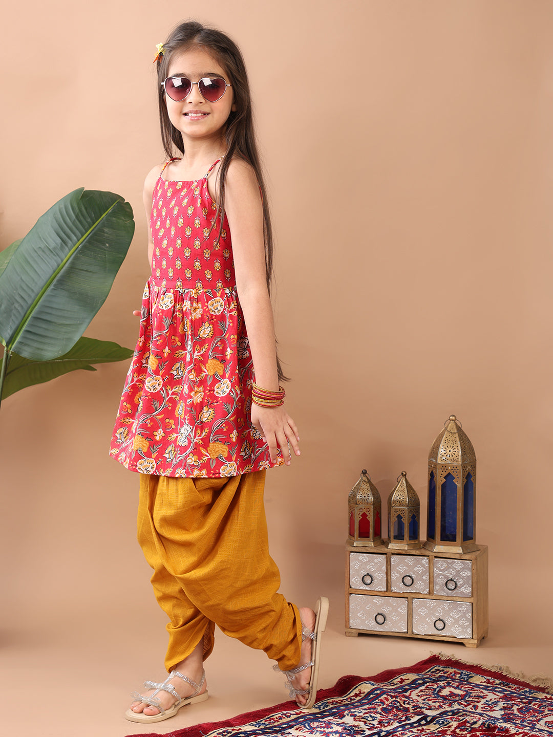 Red Floral printed sleeveless Kurti paired with Yellow Dhoti