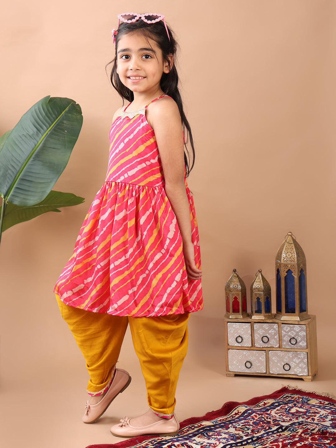 Pink Lehriya printed sleeveless Kurti paired with Yellow Dhoti