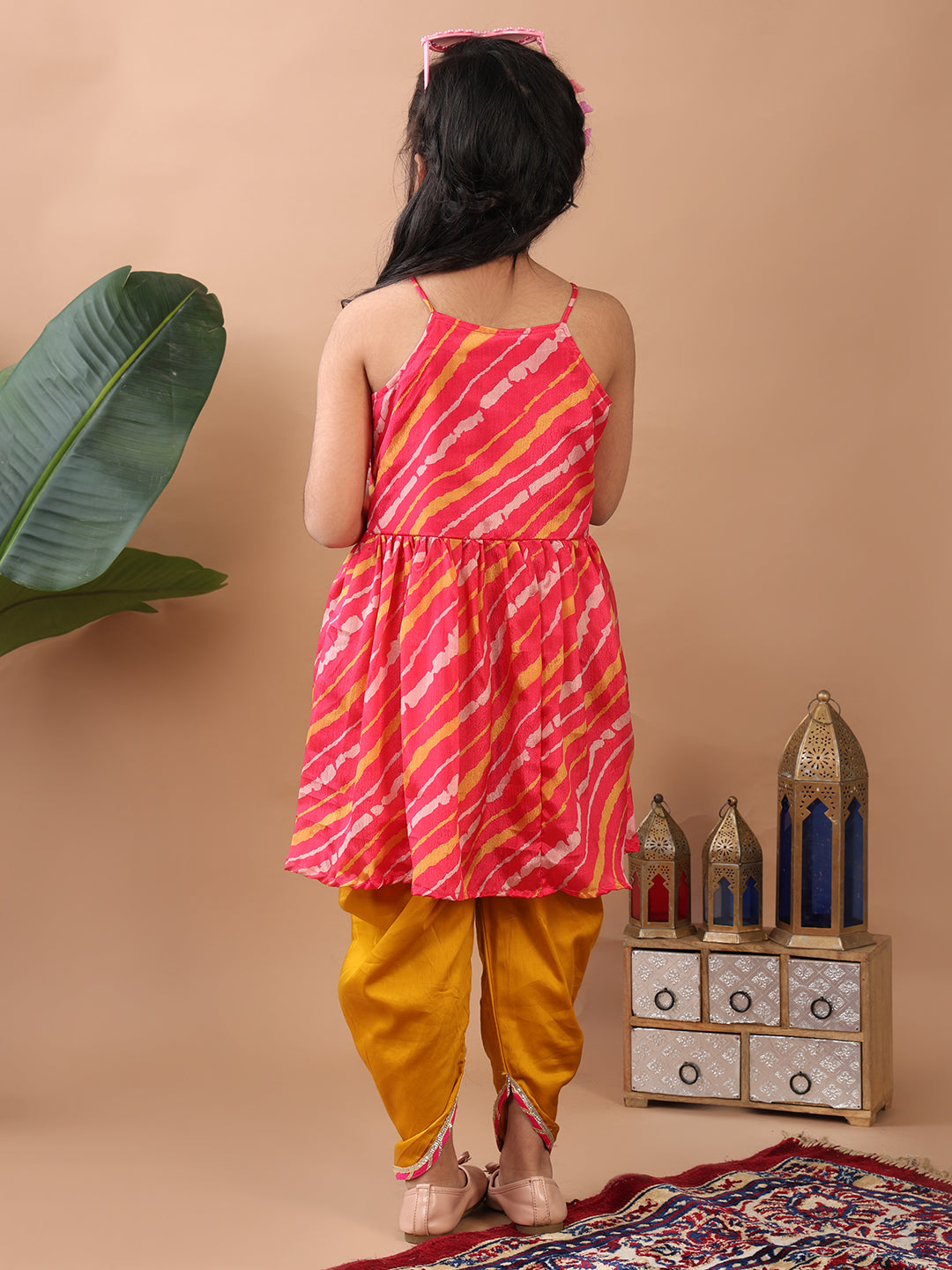 Pink Lehriya printed sleeveless Kurti paired with Yellow Dhoti