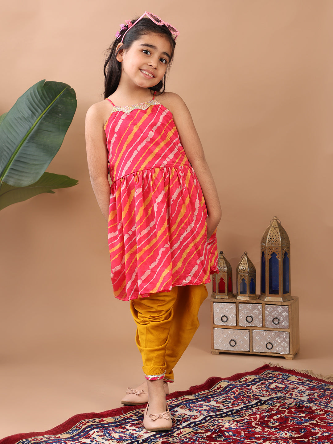 Pink Lehriya printed sleeveless Kurti paired with Yellow Dhoti