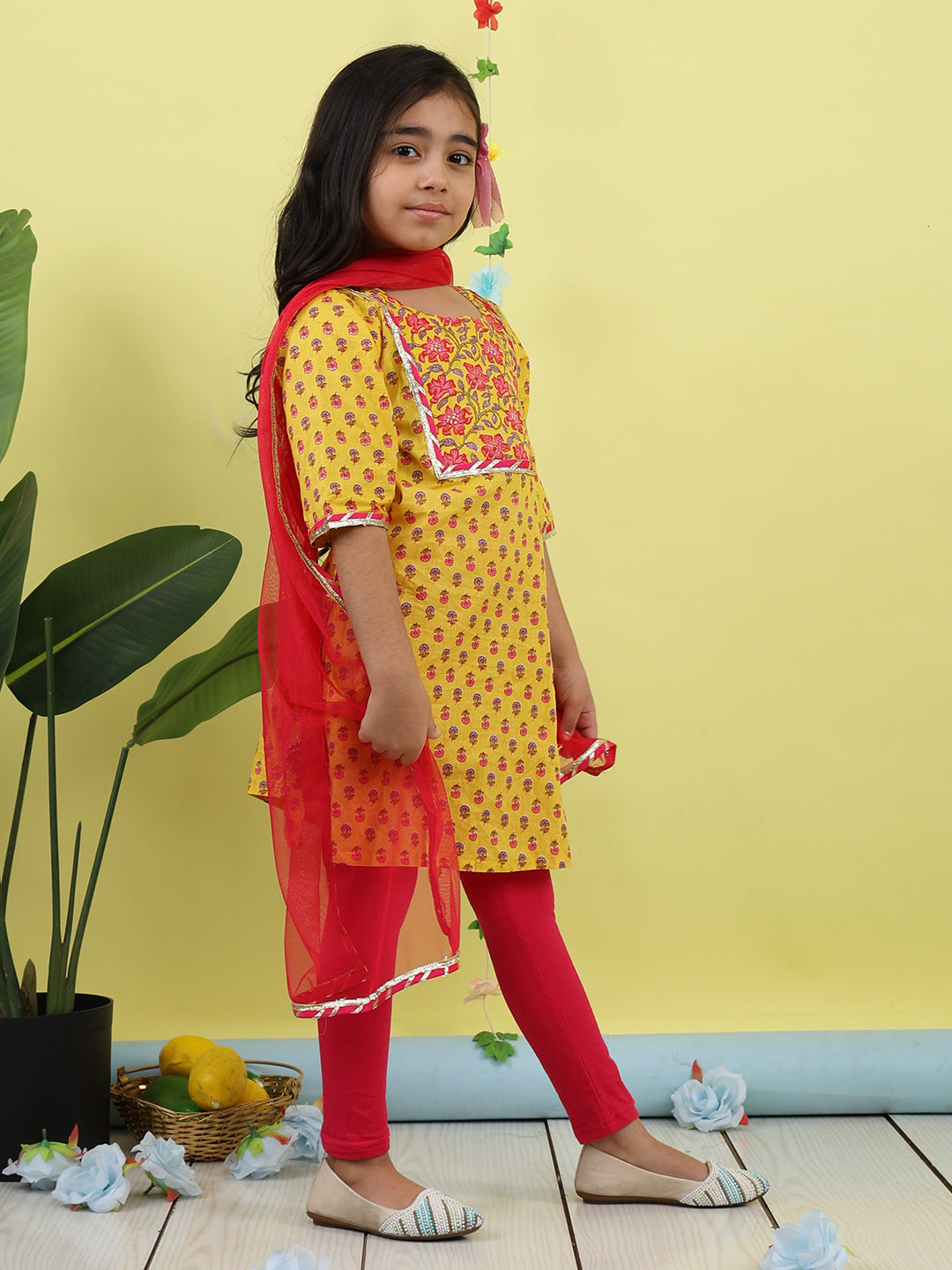 Yellow 3/4 sleeves printed cotton kurti paired with Pink leggings with Dupatta
