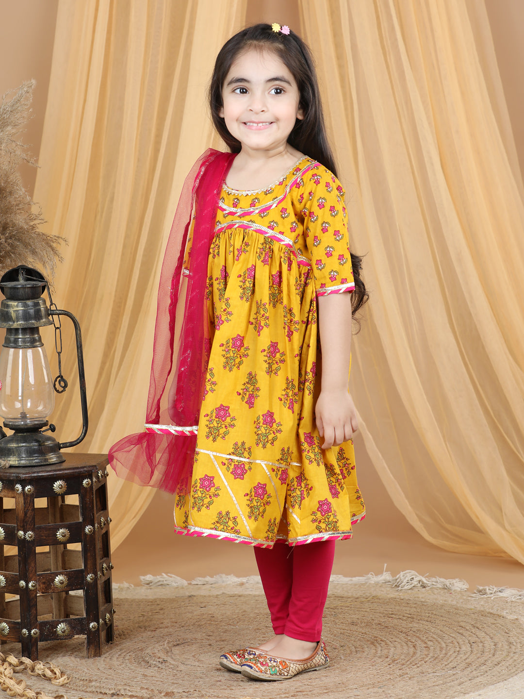 Yellow printed flared style kurti with pink leggings
