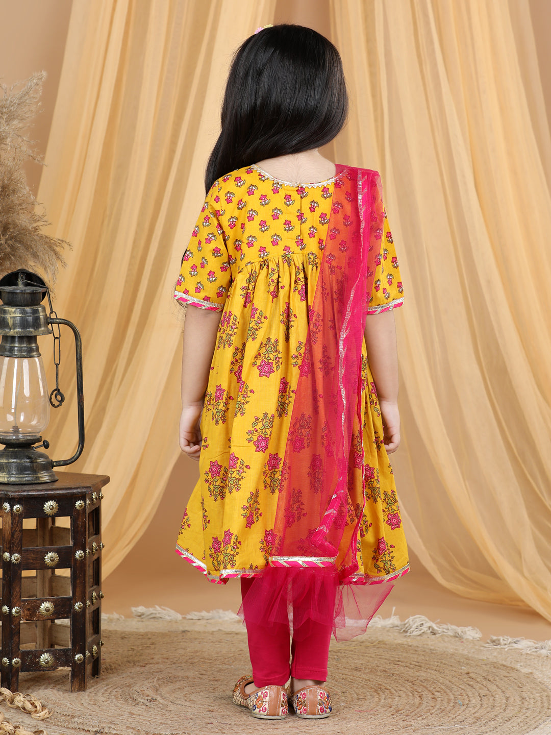 Yellow printed flared style kurti with pink leggings
