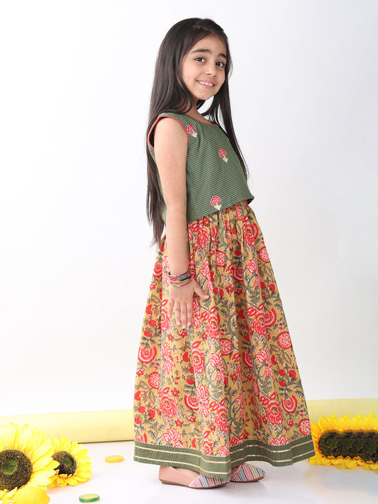 Green sleeveless embroidered blouse paired with printed lehenga