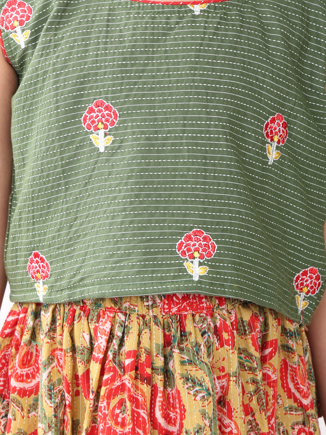 Green sleeveless embroidered blouse paired with printed lehenga