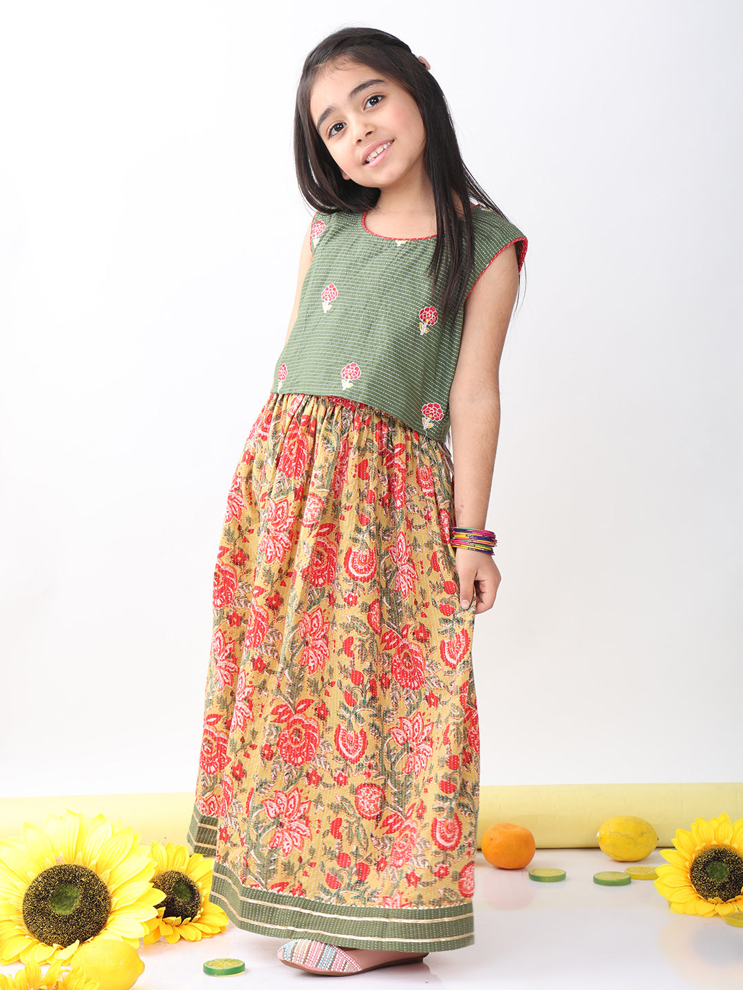 Green sleeveless embroidered blouse paired with printed lehenga
