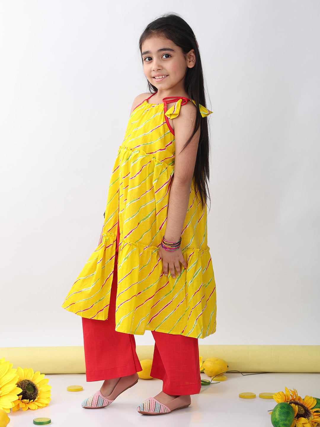 Yellow sleeveless lehriya Kurti with red pant