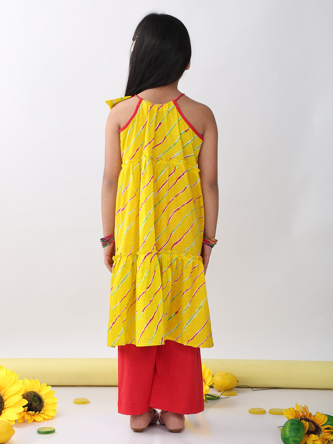 Yellow sleeveless lehriya Kurti with red pant