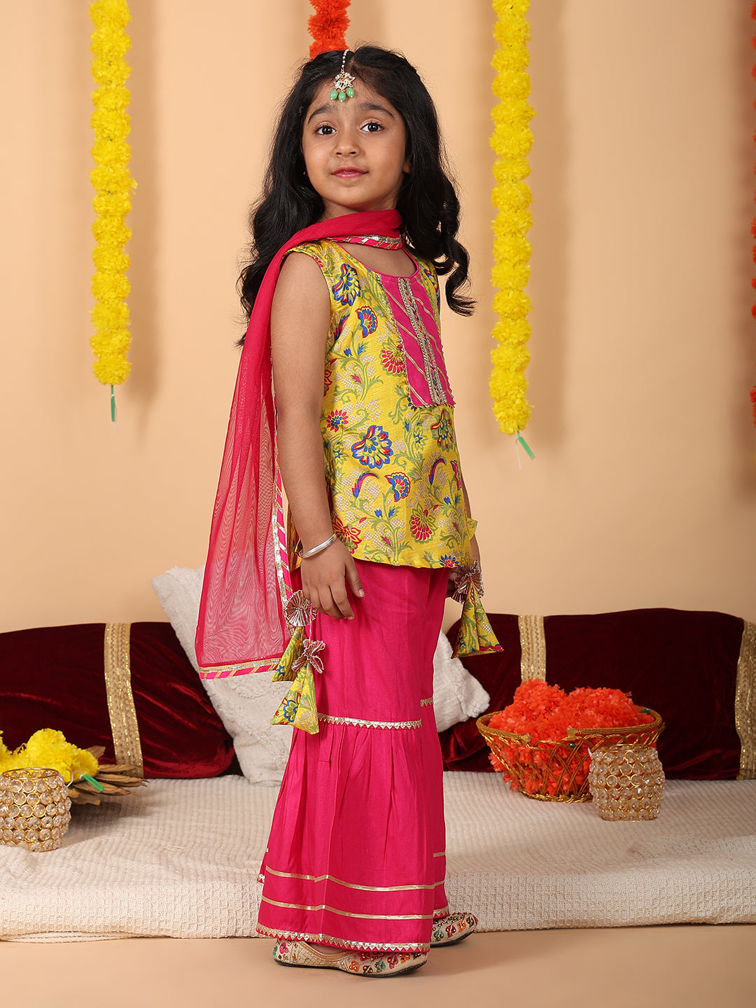 Yellow printed sleeveless kurti with Pink sharara and dupatta