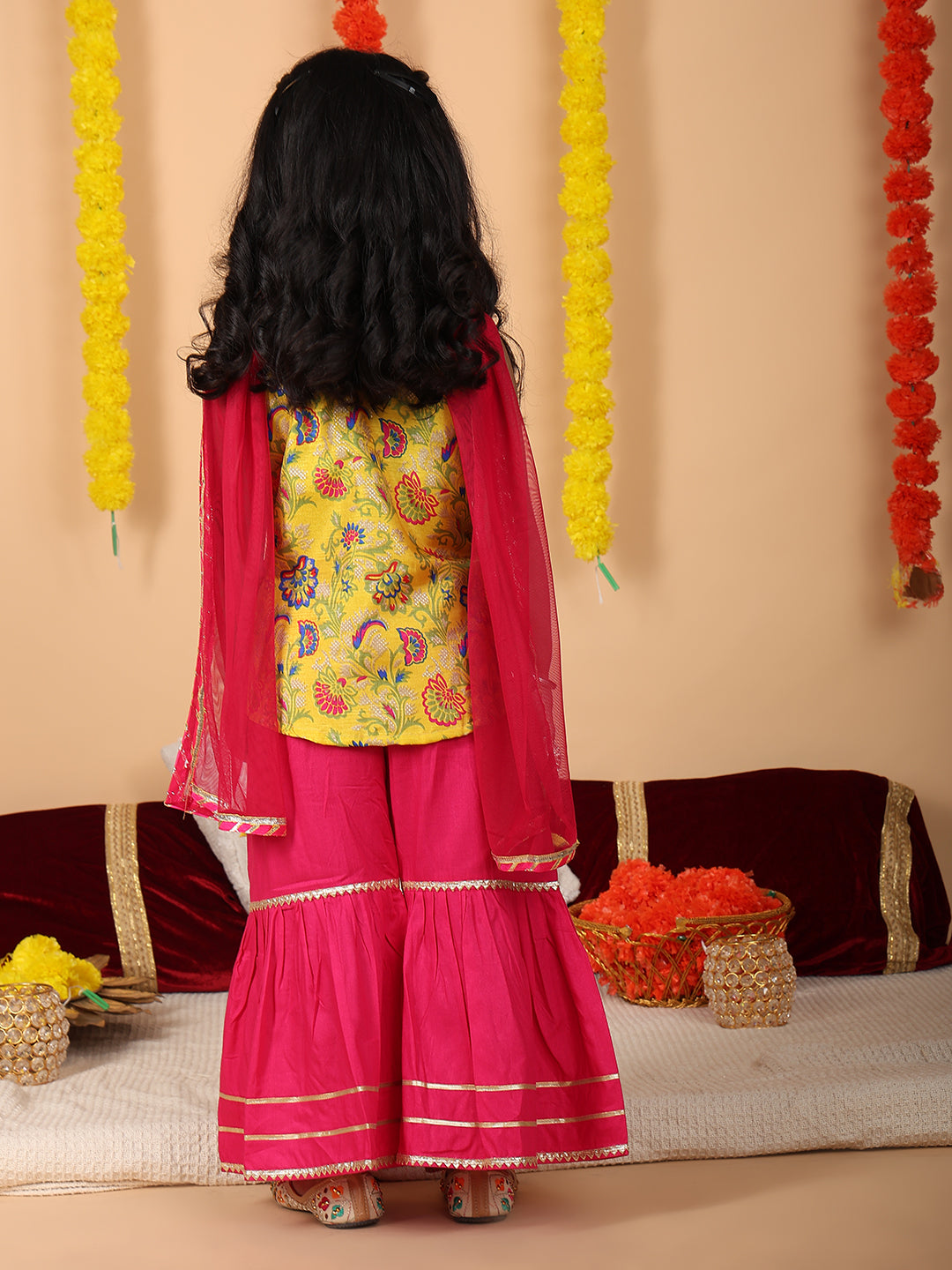 Yellow printed sleeveless kurti with Pink sharara and dupatta