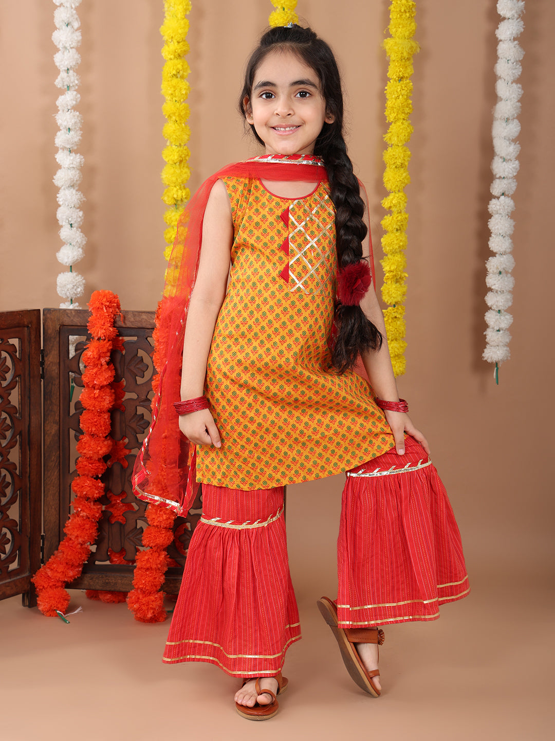 Yellow sleeveless cotton kurti with Red sharara pant and dupatta
