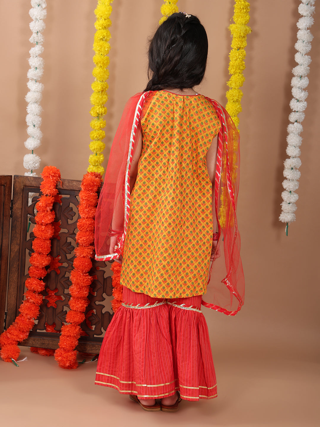 Yellow sleeveless cotton kurti with Red sharara pant and dupatta