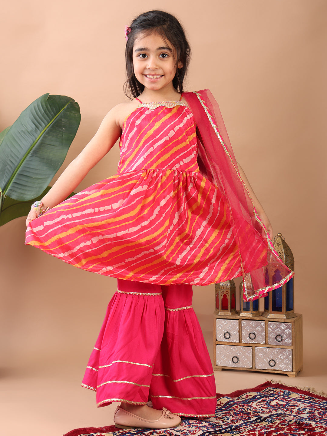 Pink Lehriya printed sleeveless Kurti paired with pink sharara pant and dupatta