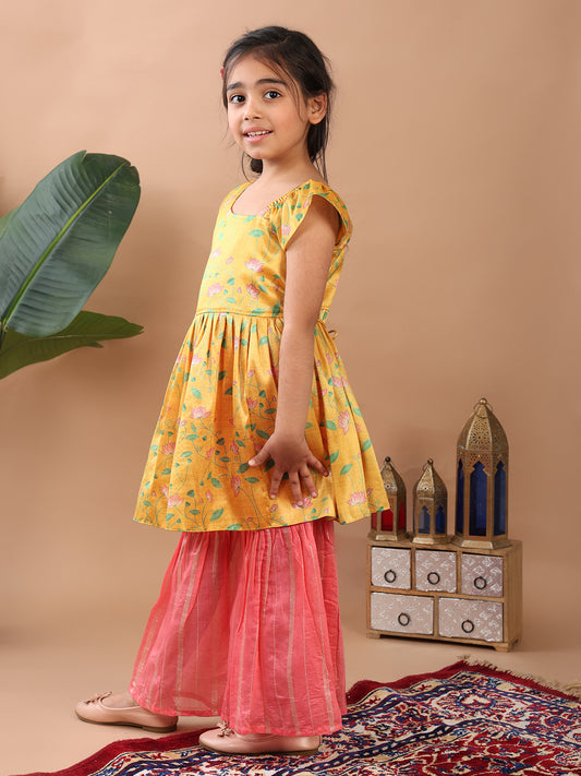 Yellow Lotus printed sleeveless Kurti paired with pink Lurex sharara pant and dupatta