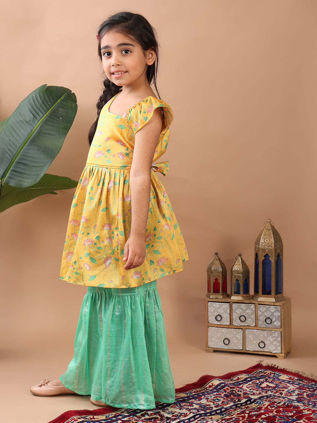 Yellow Lotus printed sleeveless Kurti paired with Green lurex sharara pant and dupatta