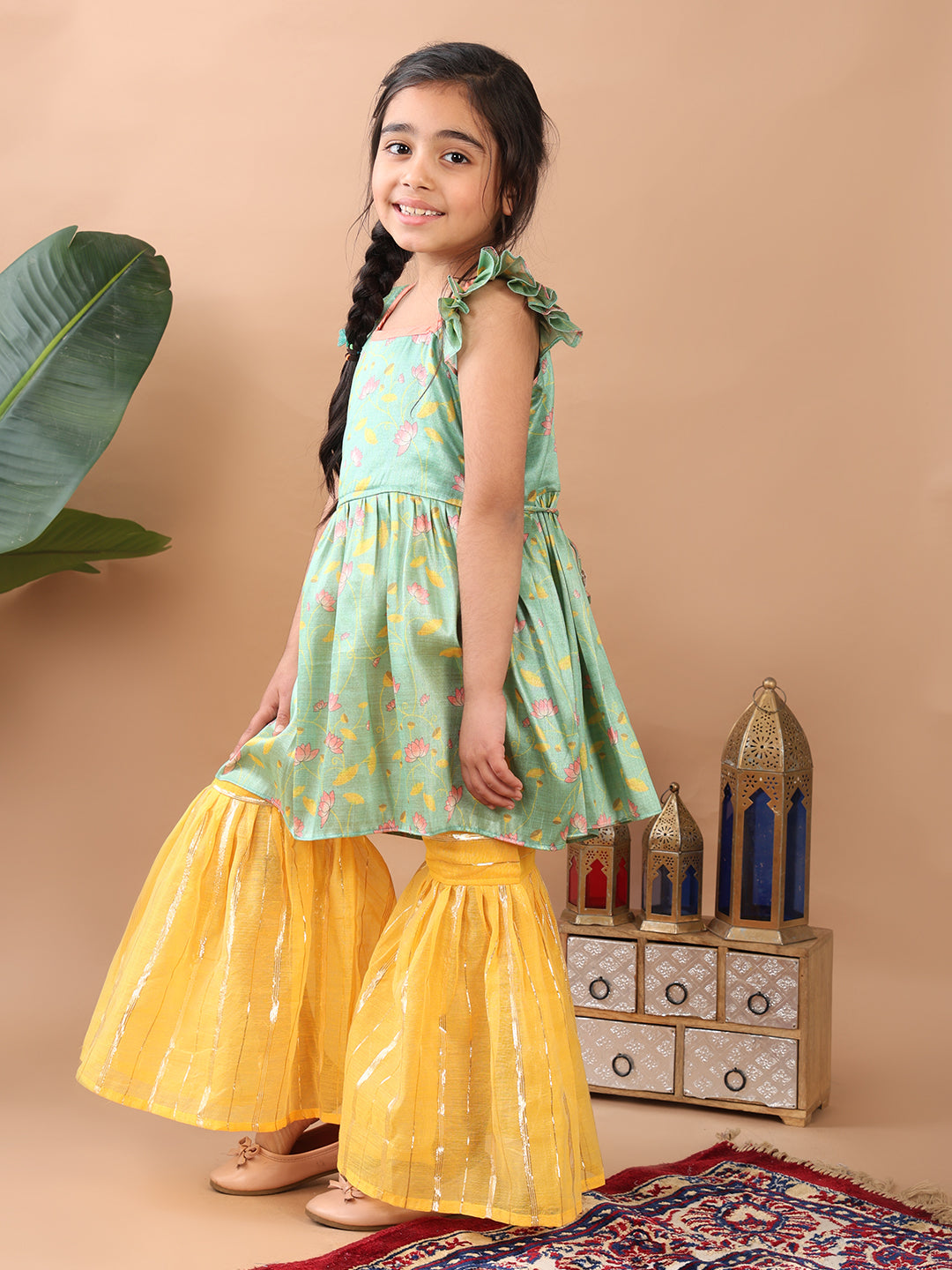 Green Lotus printed sleeveless Kurti paired with yellow Lurex sharara pant and dupatta