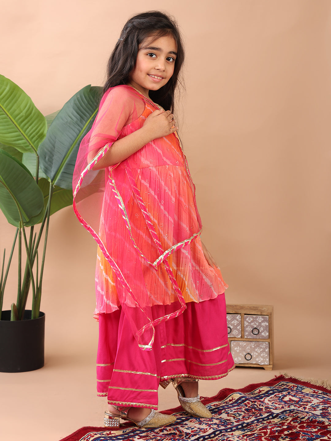 Pink Crushed Lehriya printed sleeveless Kurti paired with pink sharara pant and dupatta
