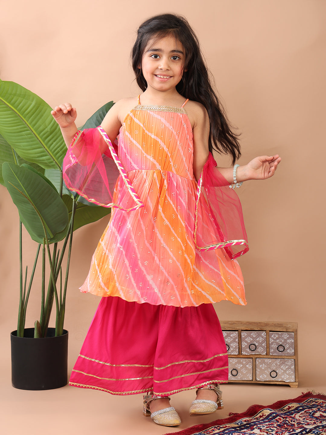 Pink Crushed Lehriya printed sleeveless Kurti paired with pink sharara pant and dupatta