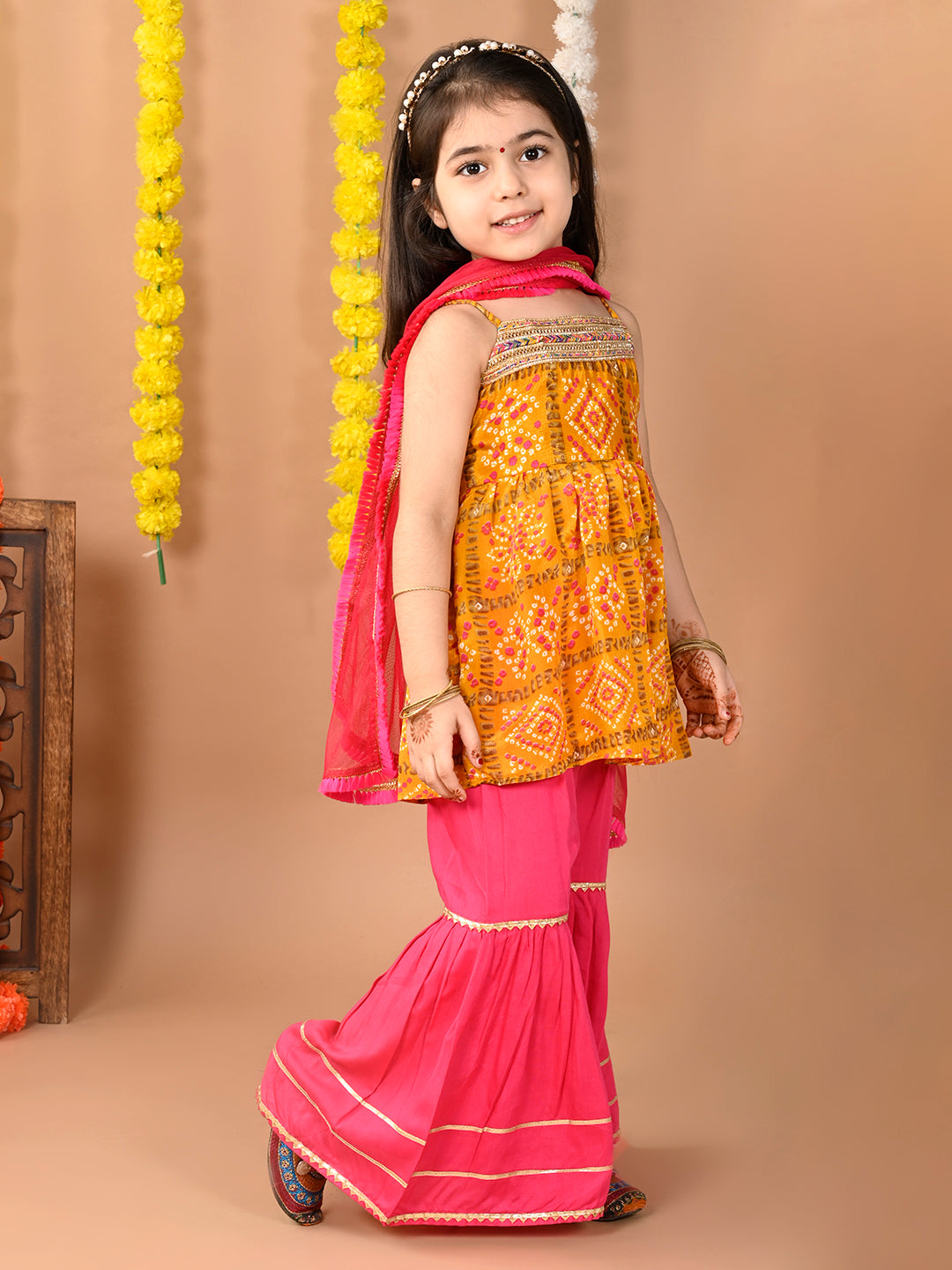 Yellow sleeveless muslin kurti with Sharara and dupatta