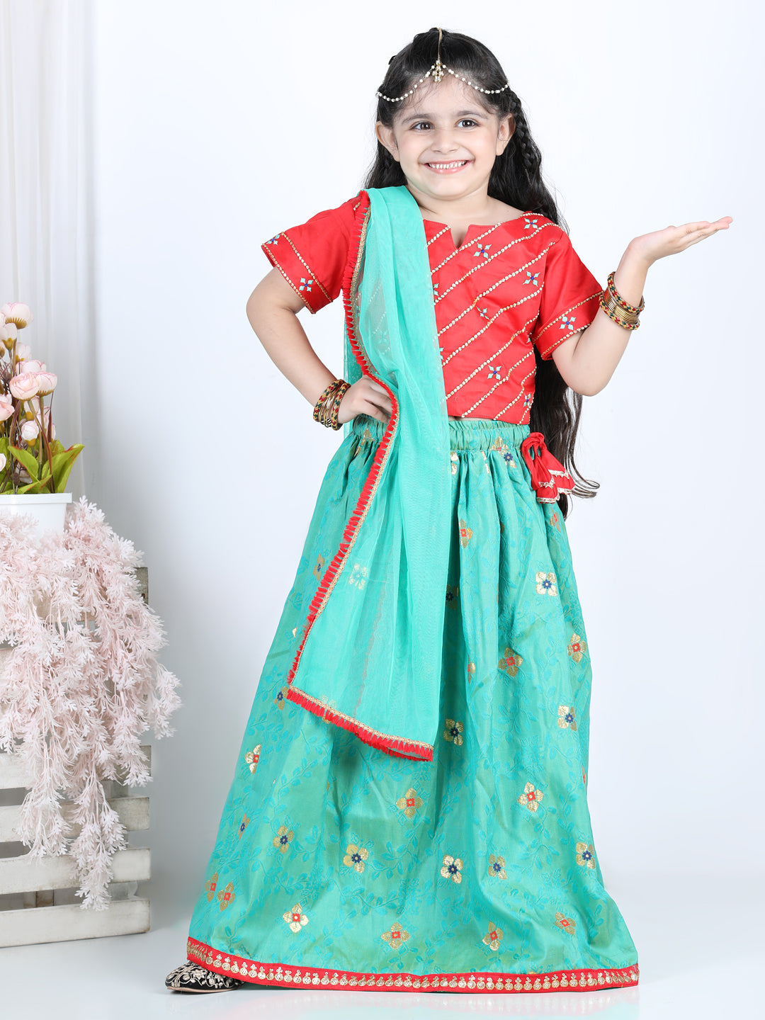 Red brocade top with green lehenga and dupatta