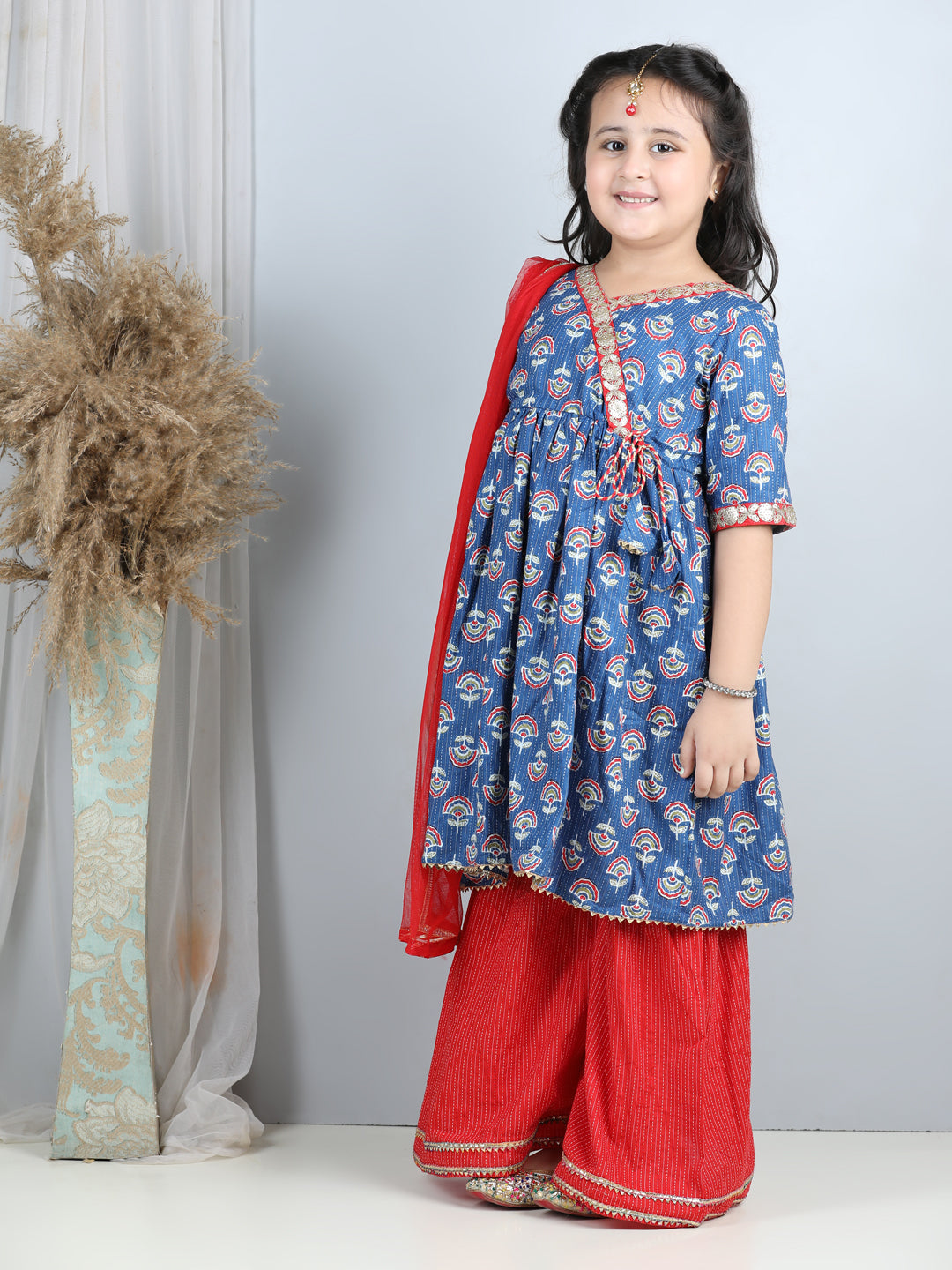 Blue printed kurti with red sharara and dupatta