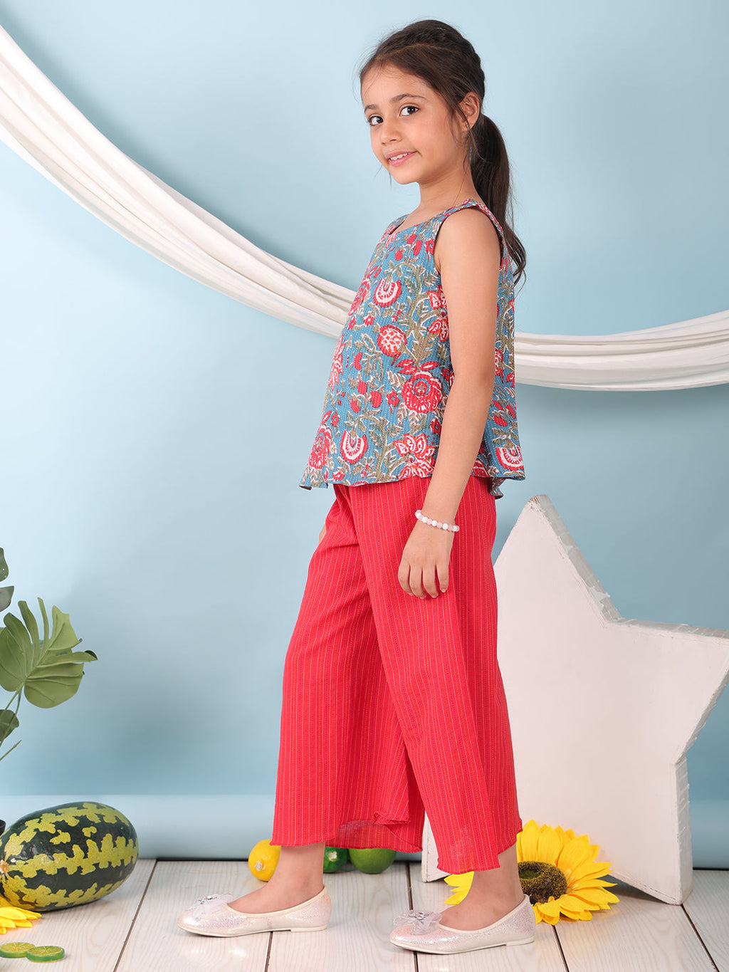 Blue floral printed  sleeveless Short Kurti with Red flair pant