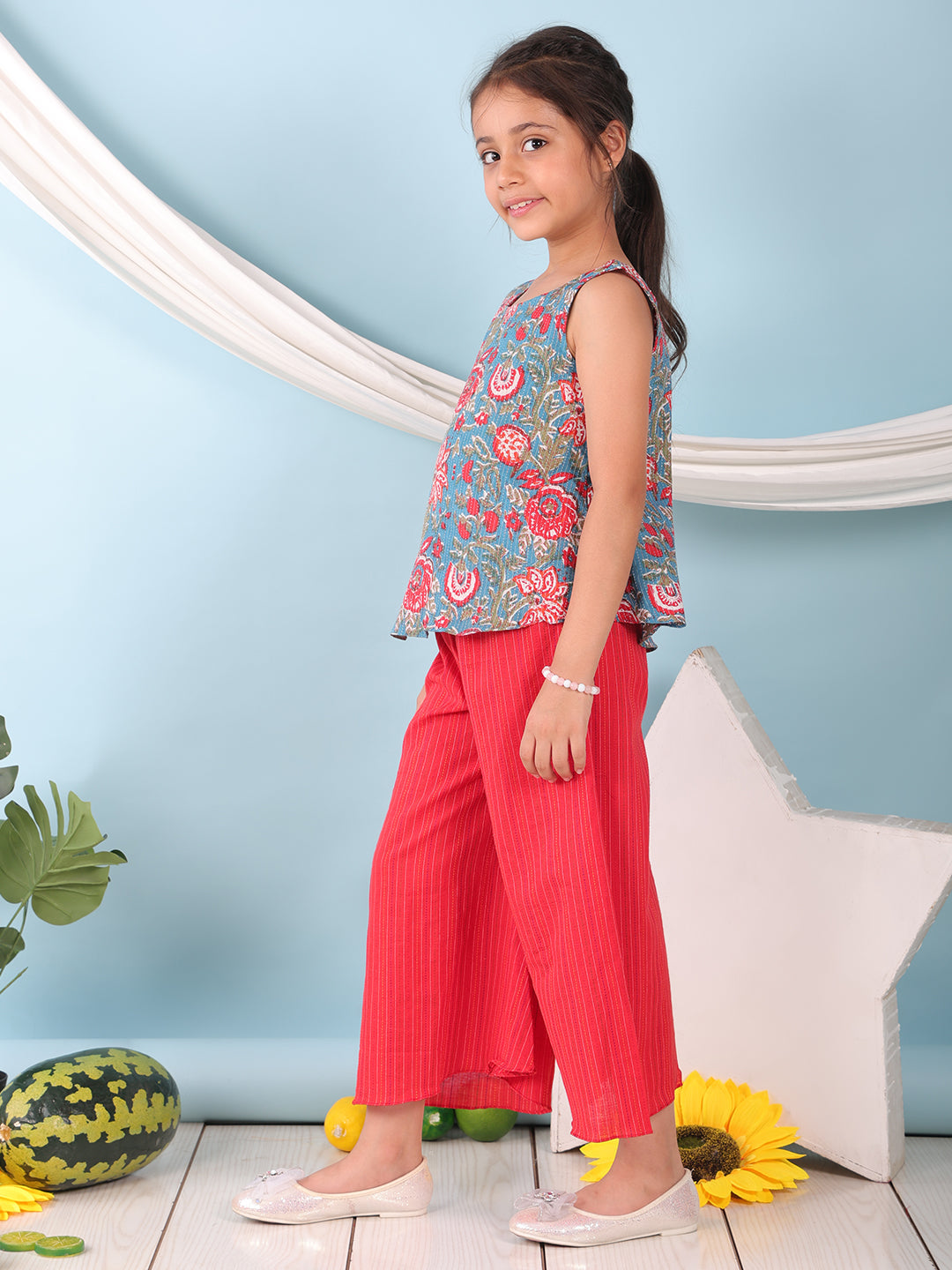 Blue floral printed  sleeveless Short Kurti with Red flair pant