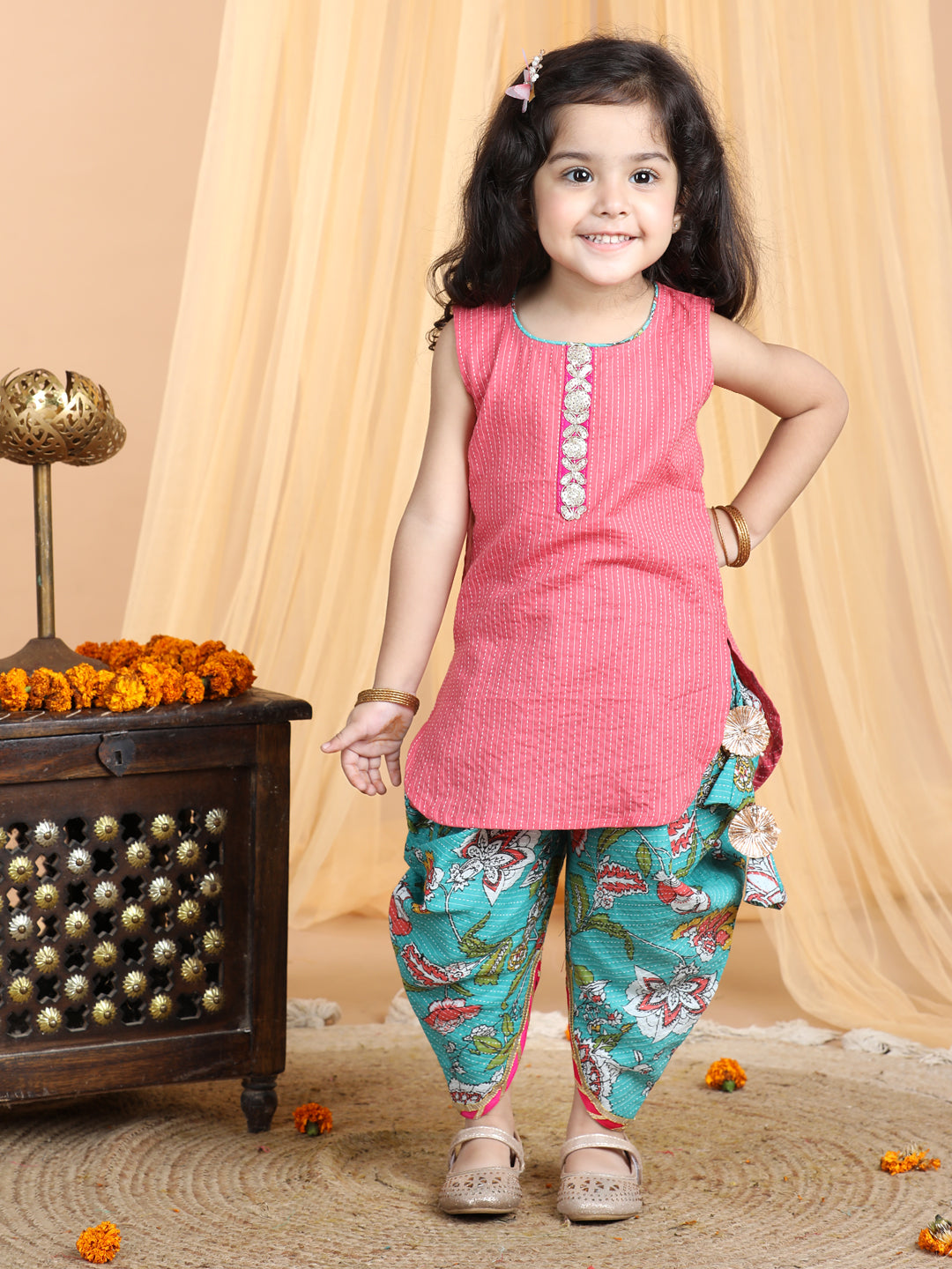 Floral printed dhoti paired with Peach katha Kurti with a lace border at the neckline