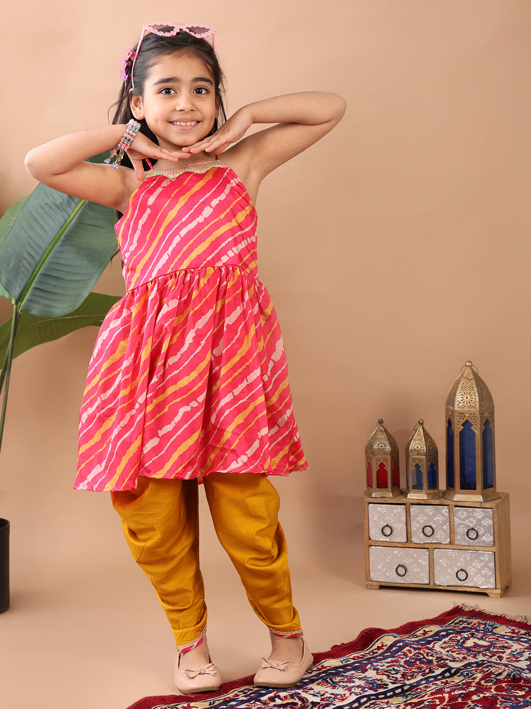 Pink Lehriya printed sleeveless Kurti  paired with Yellow Dhoti