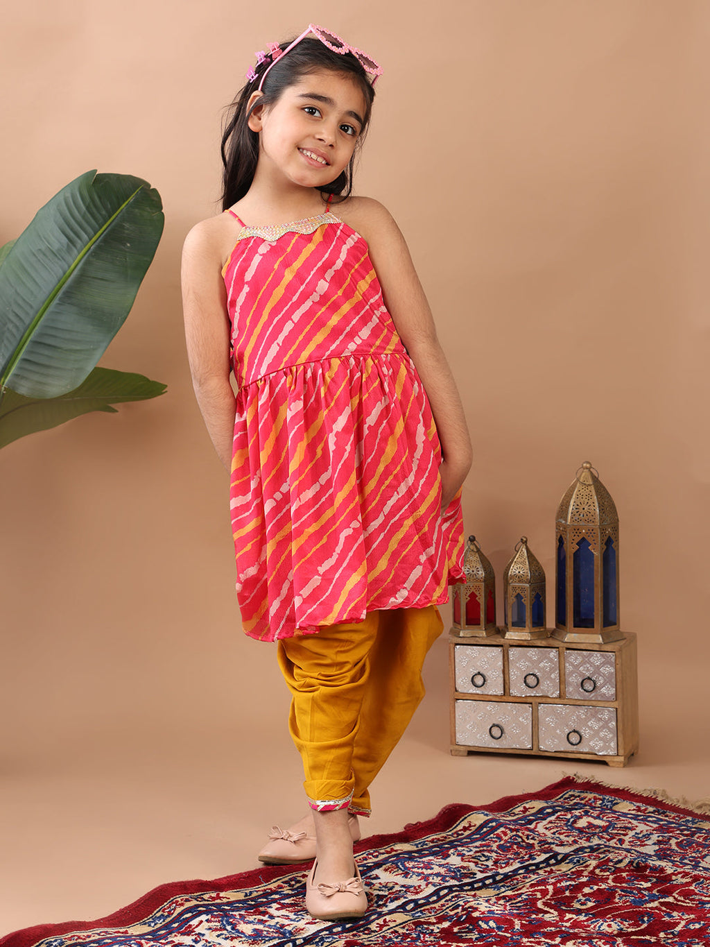 Pink Lehriya printed sleeveless Kurti  paired with Yellow Dhoti