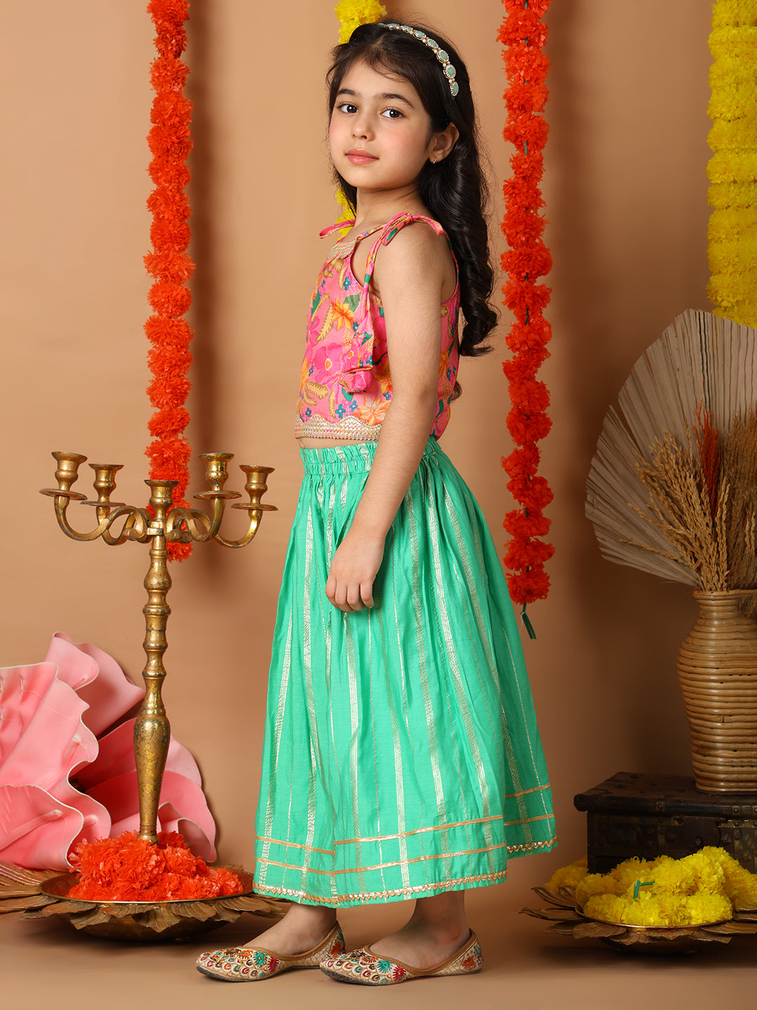 Pink Printed sleeveless top with Green golden lehenga