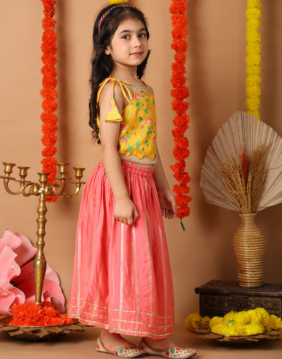 Yellow Printed sleeveless top with pink golden lehenga