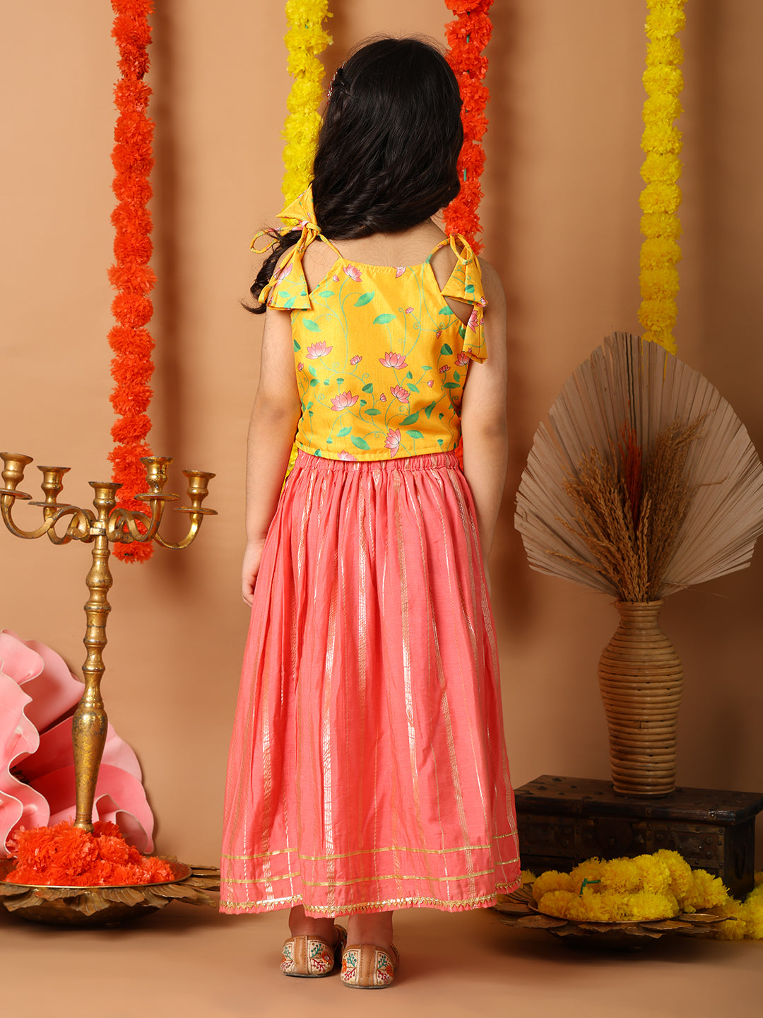 Yellow Printed sleeveless top with pink golden lehenga