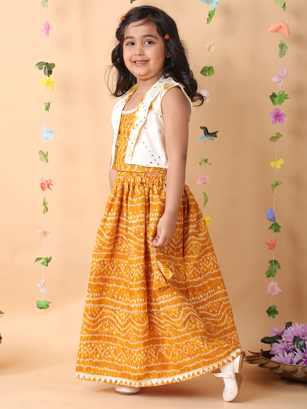 Yellow bandhani  printed  sleeveless lehenga set with mirror work jacket