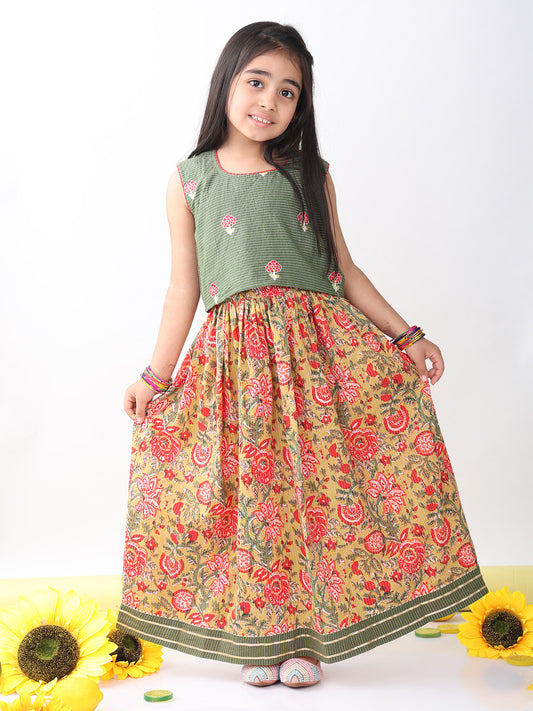 Green sleeveless embroidered blouse paired with printed lehenga