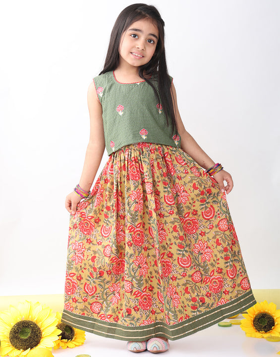Green sleeveless embroidered blouse paired with printed lehenga