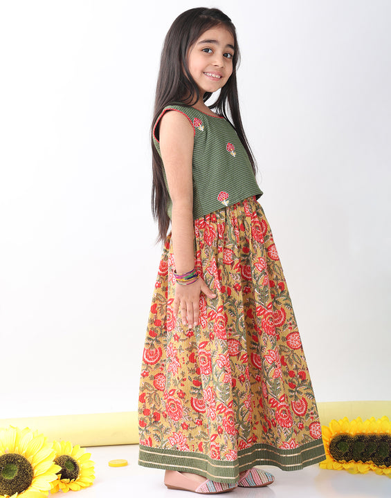 Green sleeveless embroidered blouse paired with printed lehenga