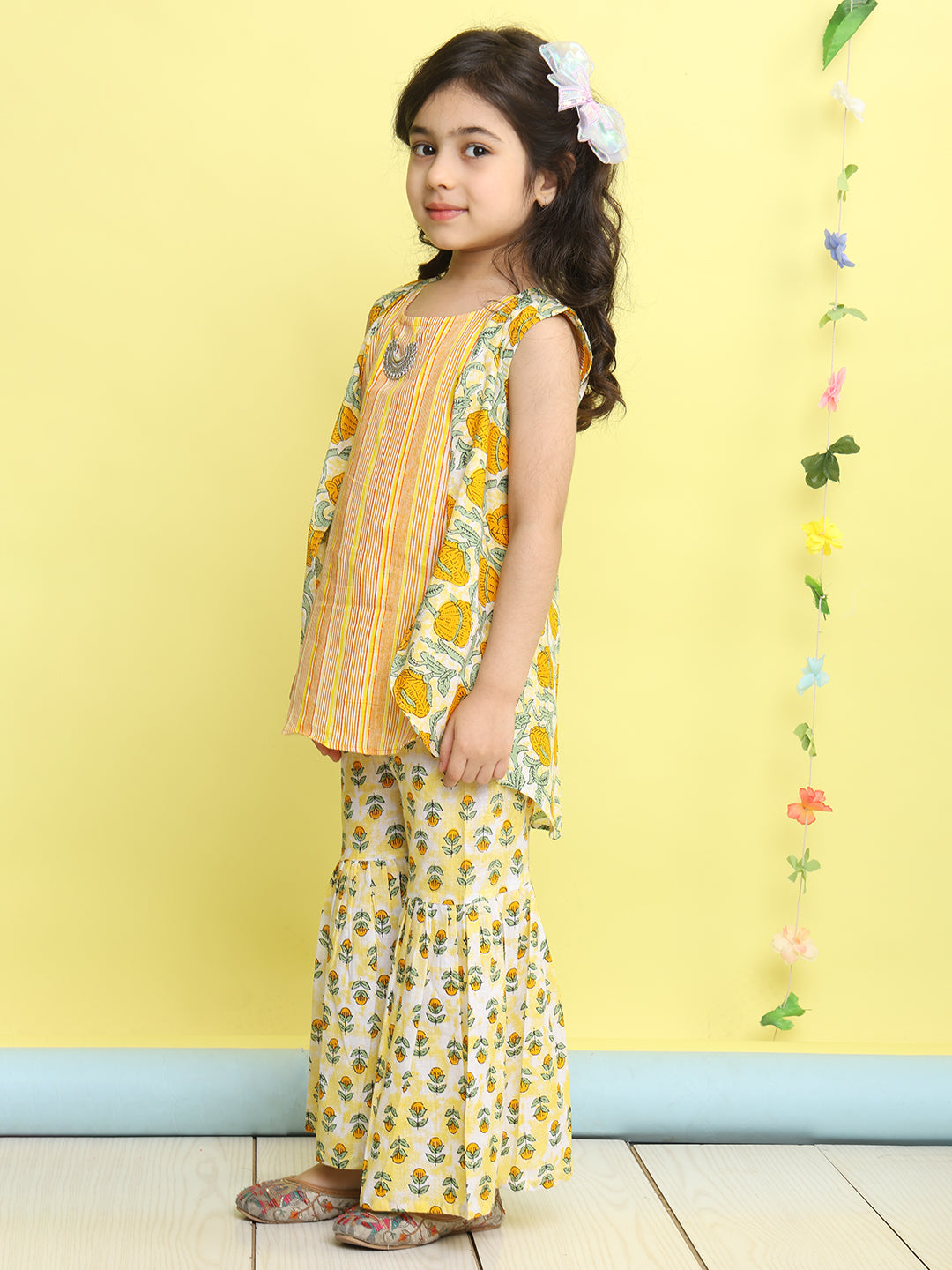 Yellow stripped sleeveless kurti with Floral sharara and jacket