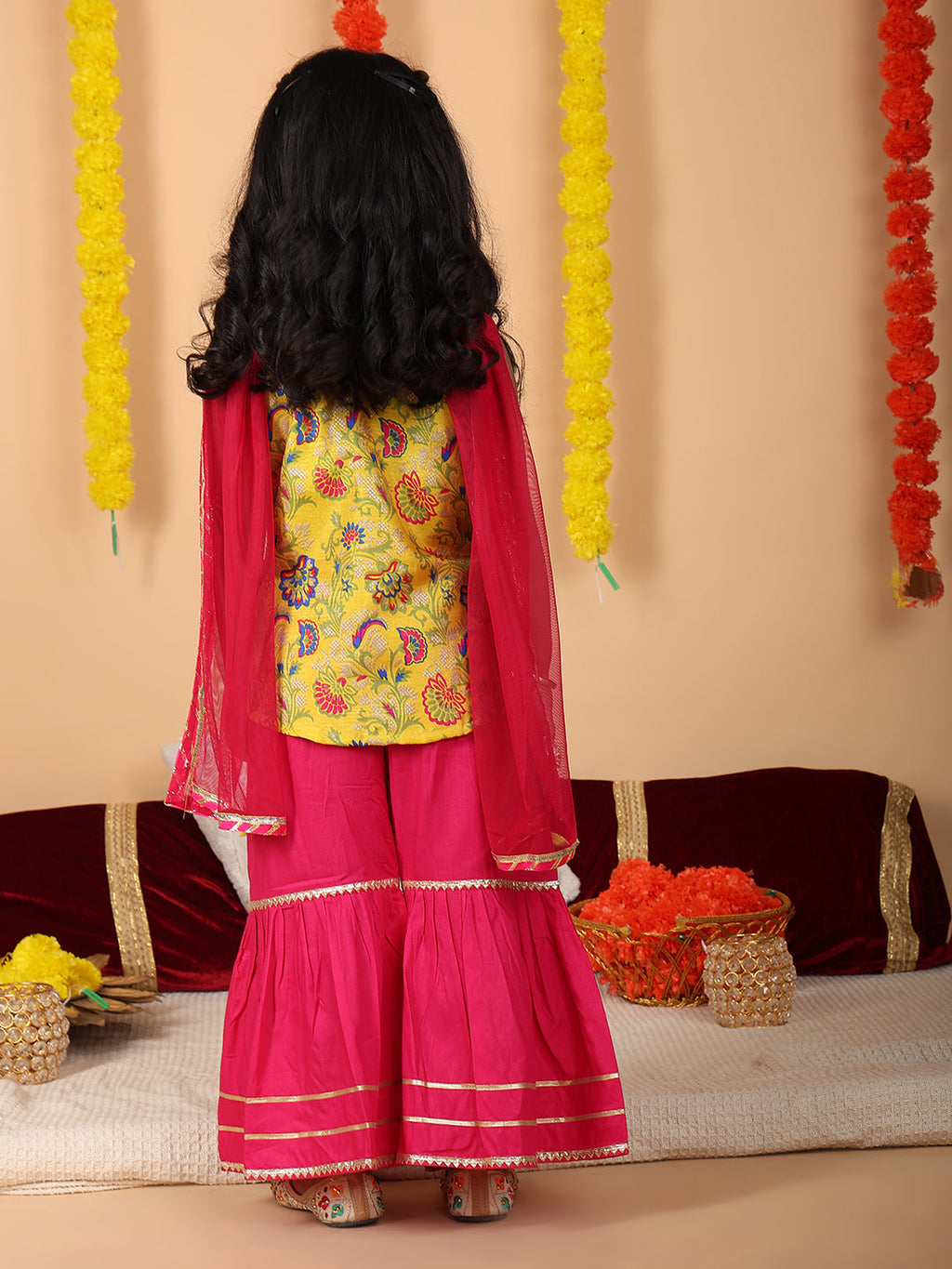 Yellow printed sleeveless kurti with Pink sharara and dupatta