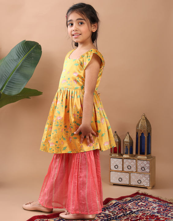 Yellow Lotus printed sleeveless Kurti  paired with pink Lurex sharara pant and dupatta