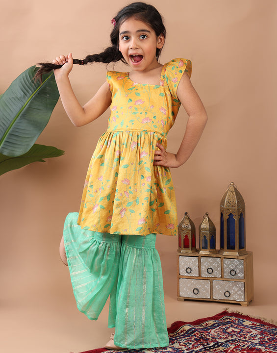 Yellow Lotus  printed sleeveless Kurti  paired with Green lurex sharara pant and dupatta