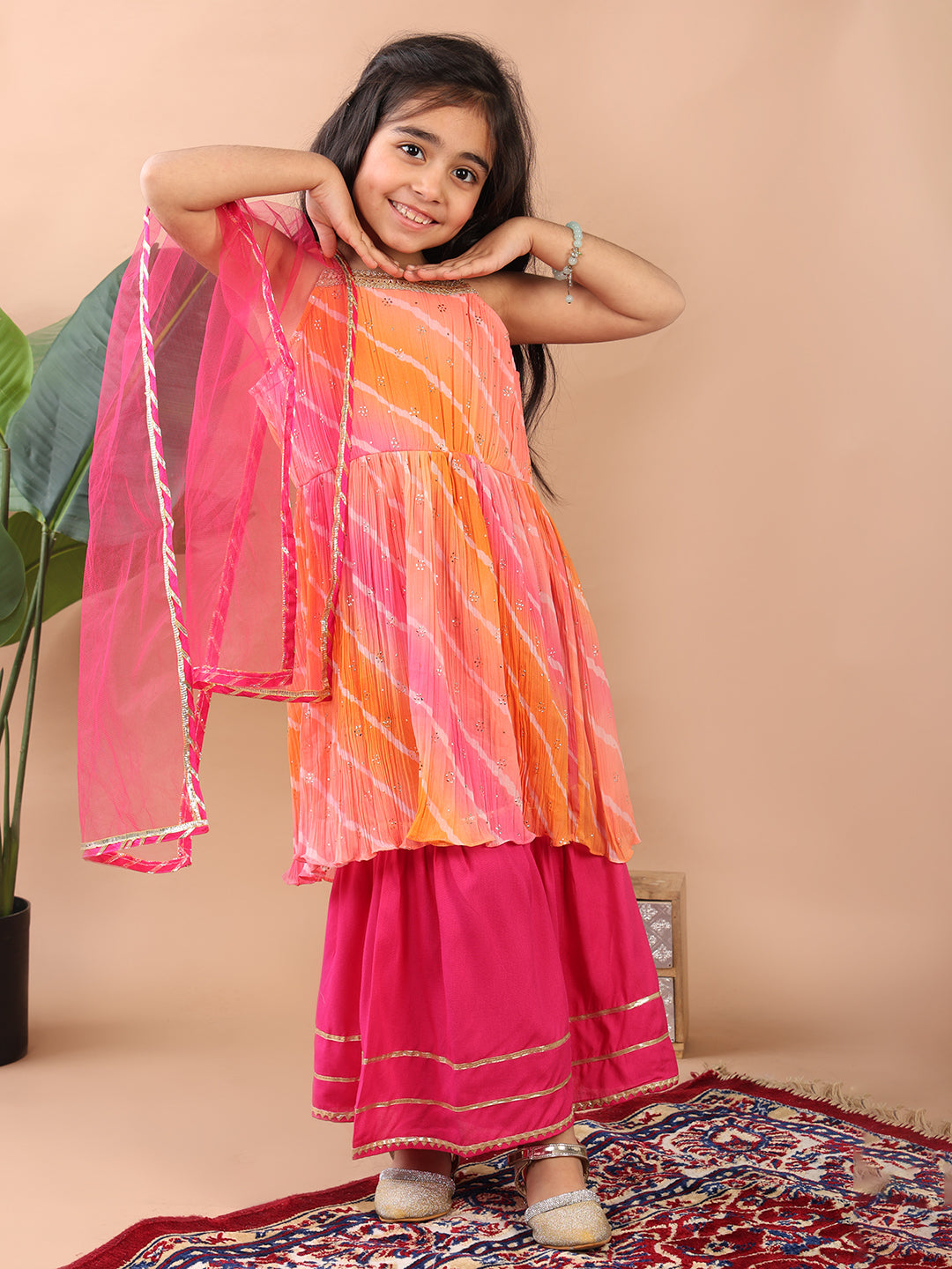 Pink Crushed Lehriya printed sleeveless Kurti  paired with pink sharara pant and dupatta