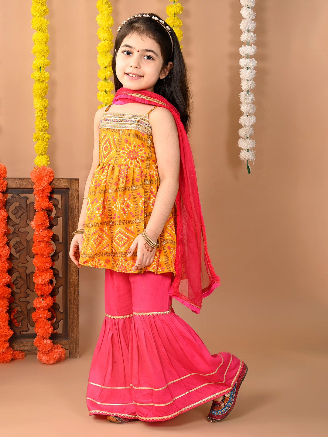 Yellow sleeveless muslin kurti with  Sharara and dupatta