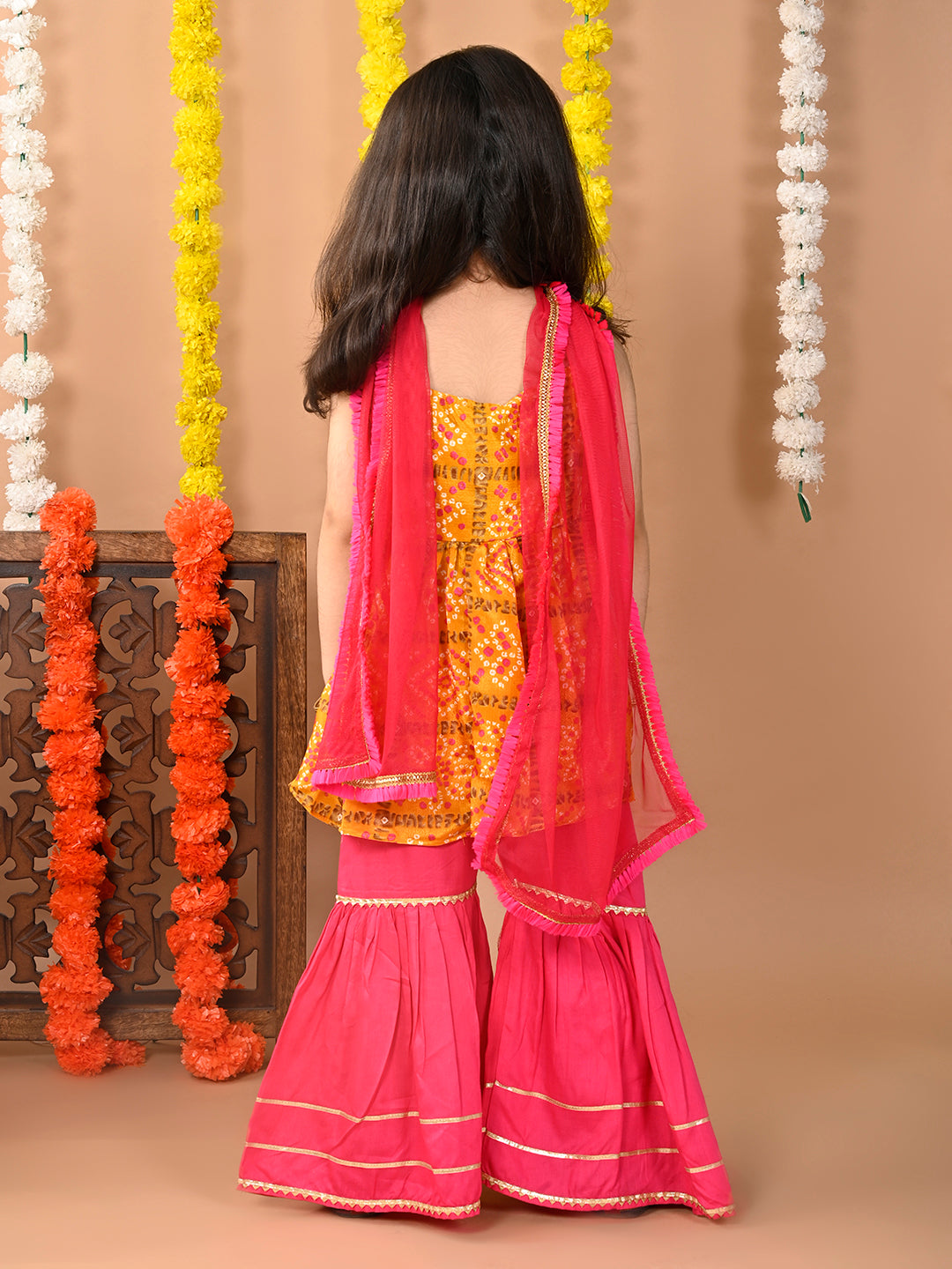 Yellow sleeveless muslin kurti with  Sharara and dupatta