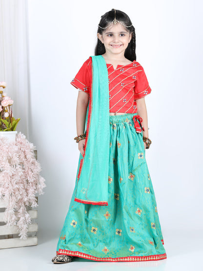 Red brocade top with green lehenga and dupatta
