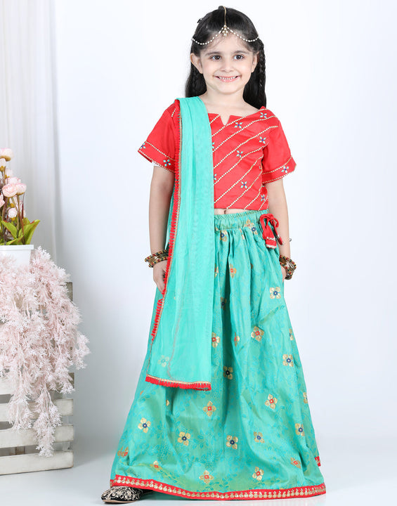 Red brocade top with green lehenga and dupatta