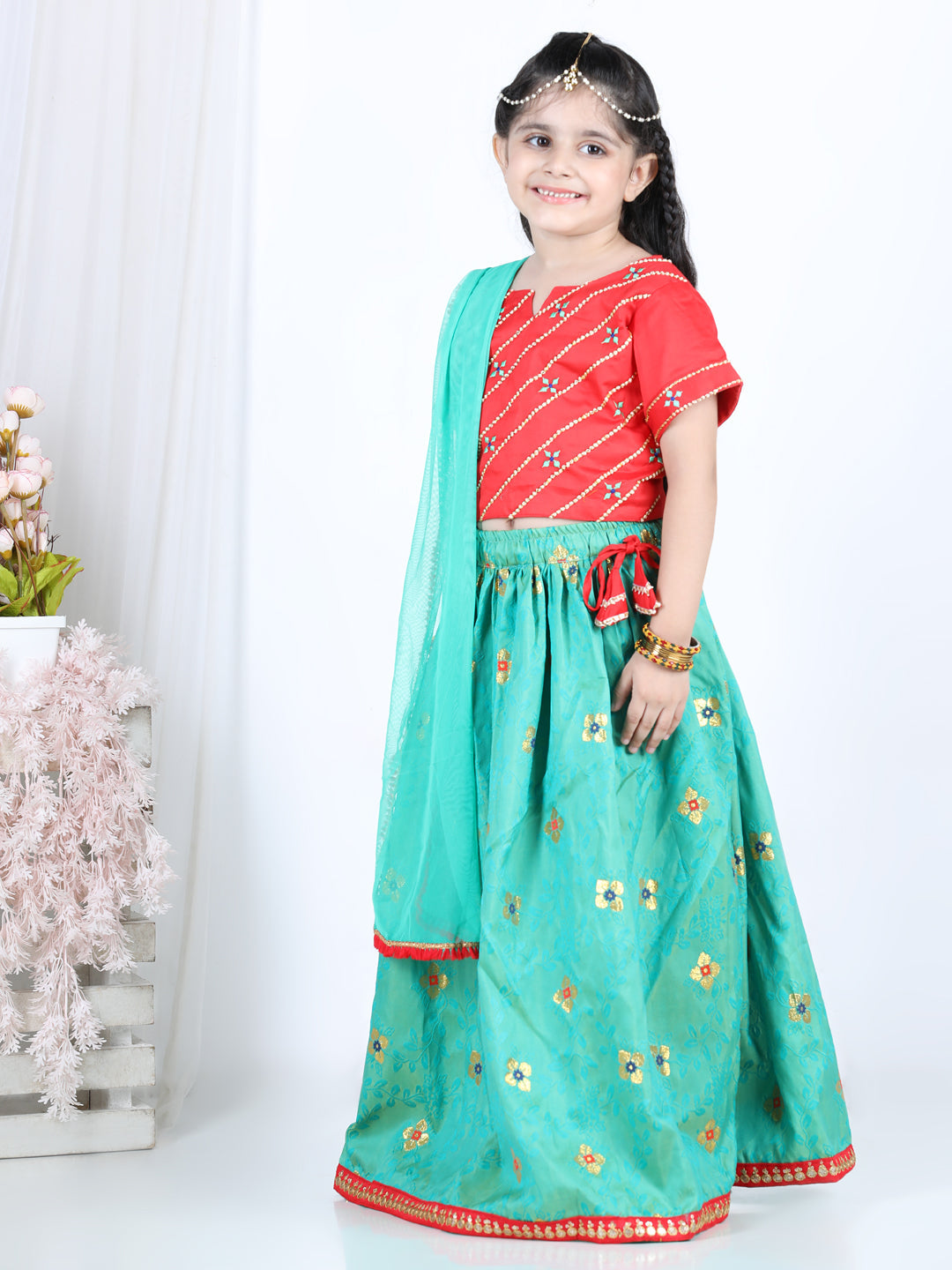 Red brocade top with green lehenga and dupatta